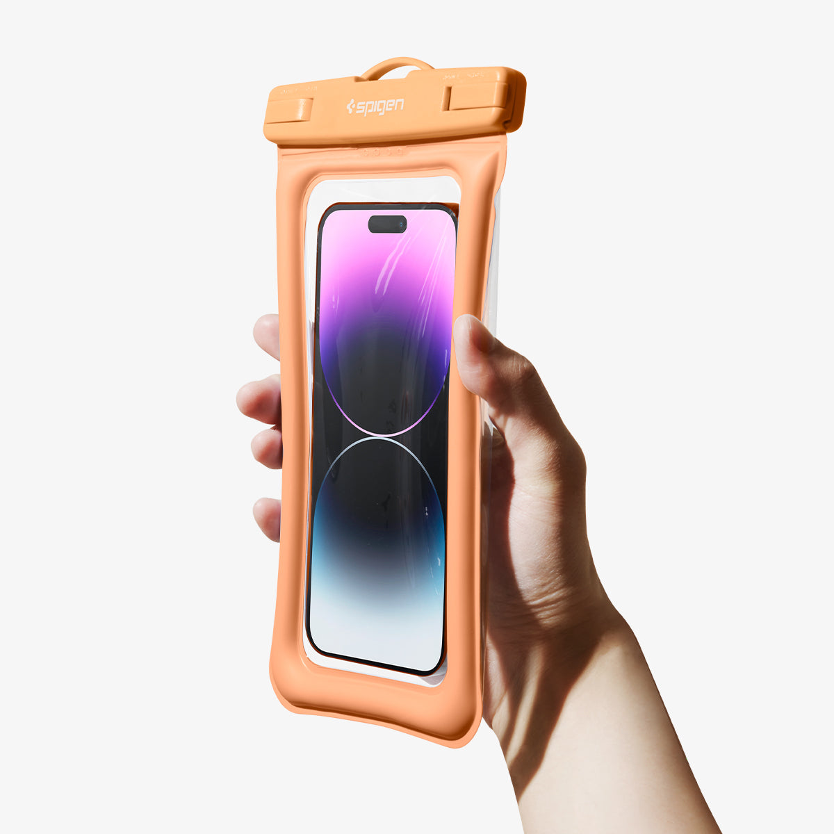 ACS06011 - AquaShield Waterproof Floating Case A610 in Apricot showing the single handedly holding the device inside a waterproof case with ease and comfort