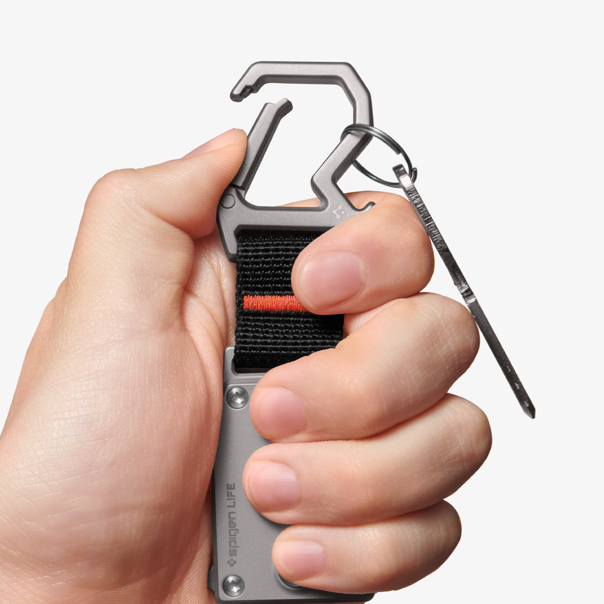 AHP06270 - Spigen Pocket Knife LF400 in Gunmetal showing a person's hand holding the pocket knife push the carabiner's lock to open with its thumb