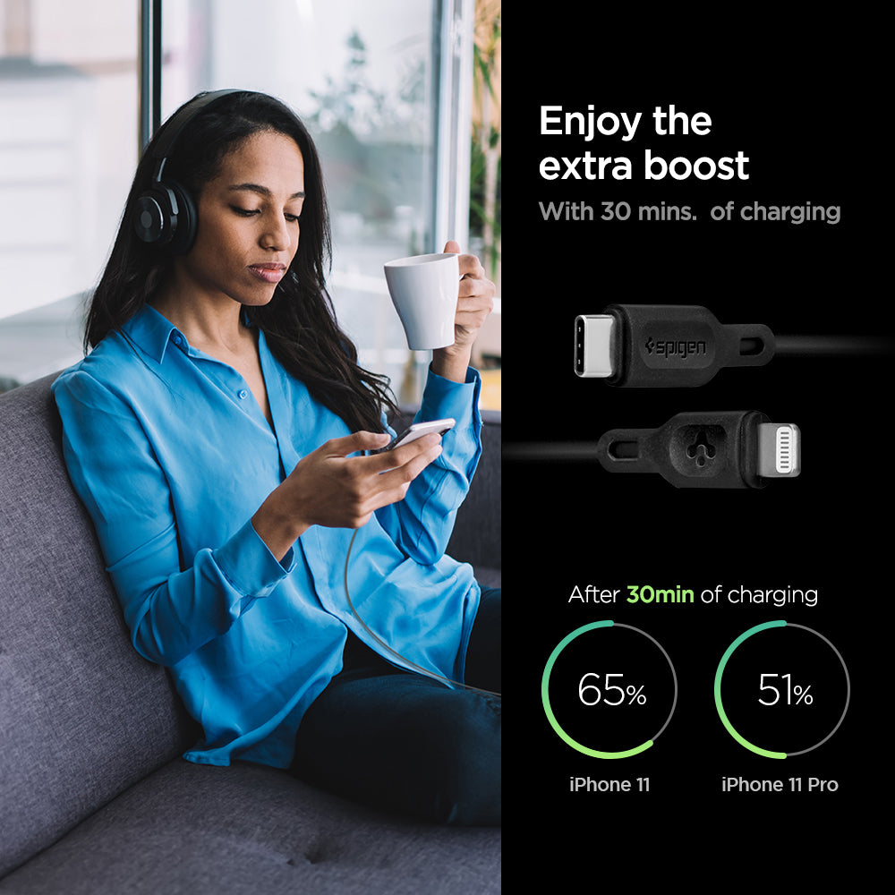 000CA27021 - DuraSync™ USB-C to Lightning Cable C10CL in Black showing the Enjoy the extra boost. With 30 mins. of charging. After 30 mins of charging, iPhone 11 (65%) and iPhone 11 Pro (51%). also showing 2 cable heads and a woman sitting holding a mug and a device in another hand