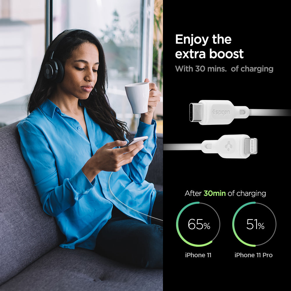 000CA25416 - DuraSync™ USB-C to Lightning Cable C10CL in White showing the Enjoy the extra boost. With 30 mins. of charging. After 30 mins of charging, iPhone 11 (65%) and iPhone 11 Pro (51%). also showing 2 cable heads and a woman sitting holding a mug and a device in another hand