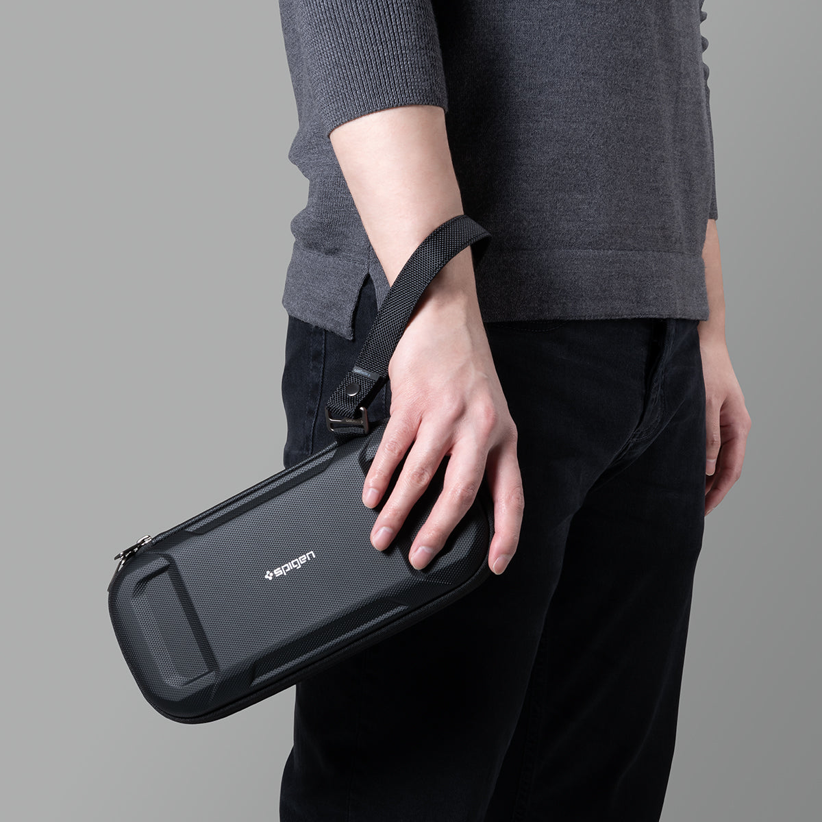 AFA05509 - Rugged Armor® Pro Slim Cable Organizer Bag in black showing a man holding the bag with the strap on his wrist